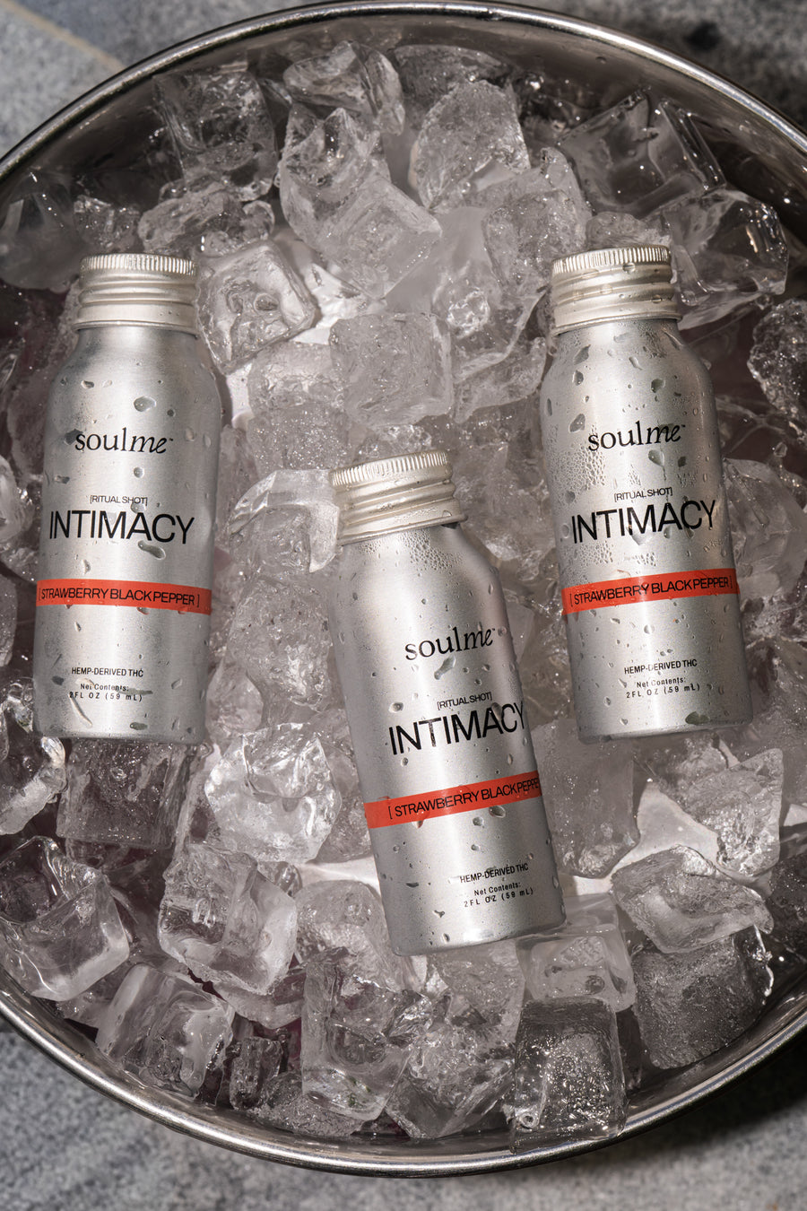 Three SoulMe Intimacy Ritual Shots chilling in an ice bucket