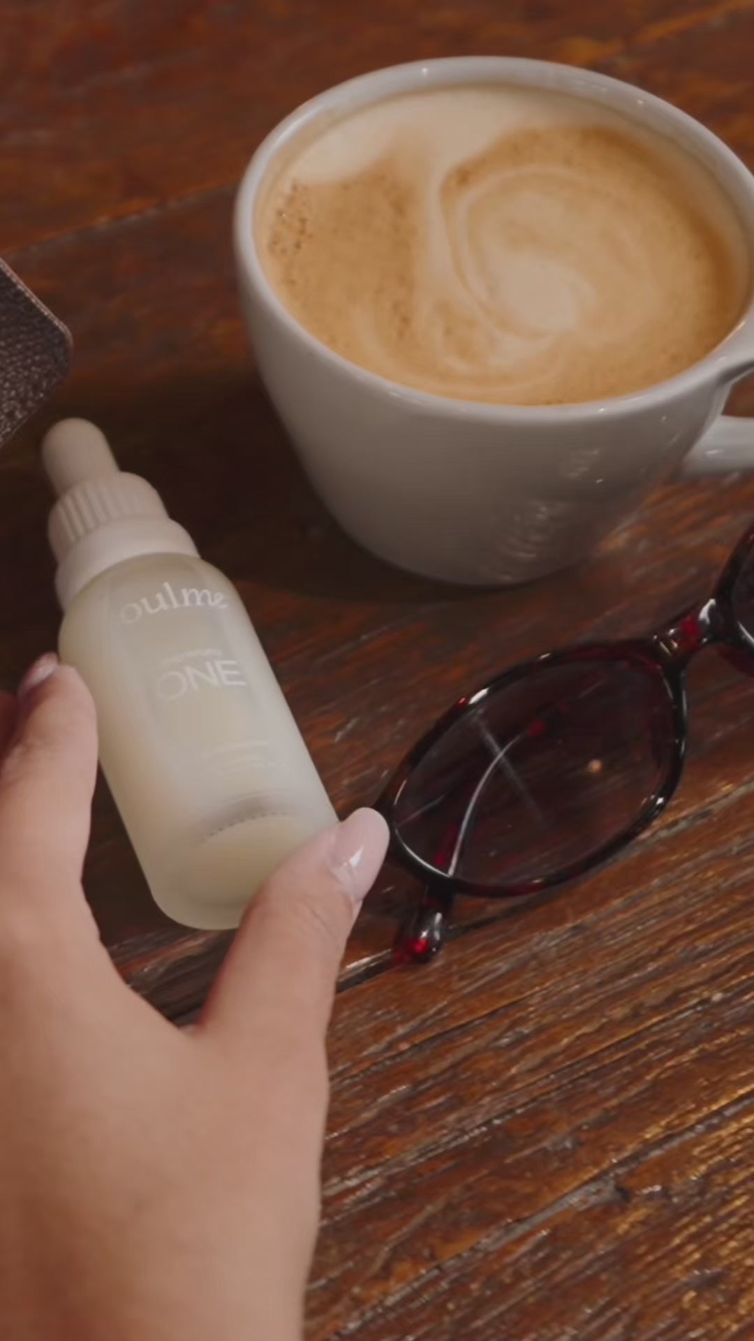 Adding SoulMe ONE to a morning coffee at a café table