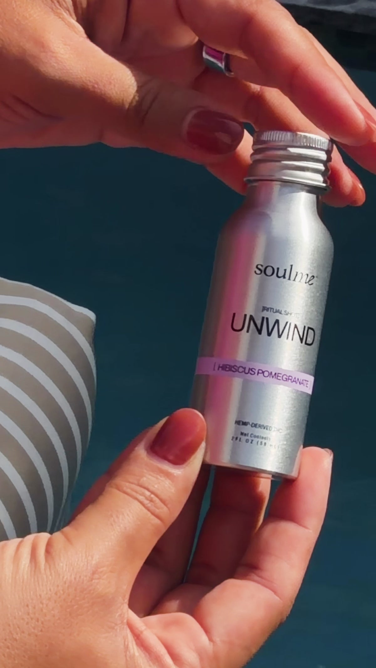 Hands opening a SoulMe Unwind Ritual Shot